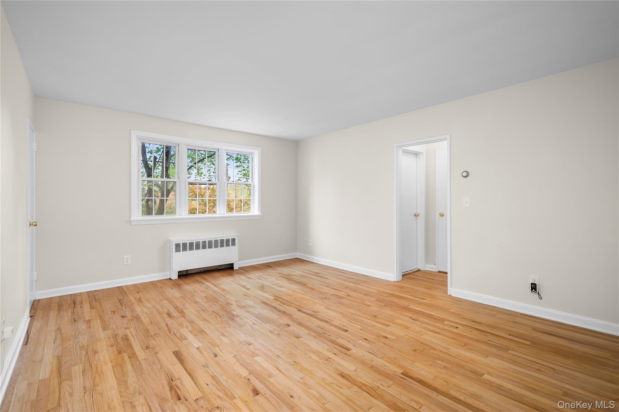 51 Cross Street, Unit 3B Yonkers, NY 10708 - Photo 7 of 18 Spacious living room featuring hardwood refinish floors, a large window for more natural light, neutral wall tones