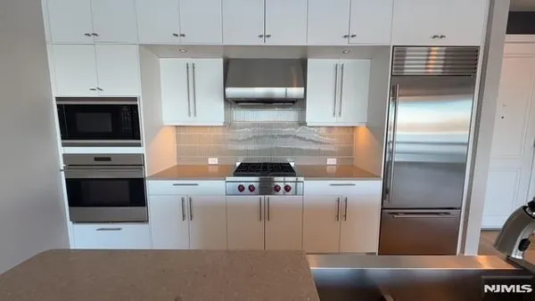 a kitchen with a stove and a refrigerator
