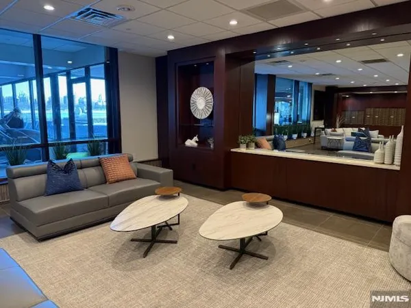 a living room with furniture a rug and a large window
