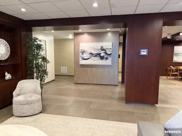 a living room with furniture and a painting on the wall