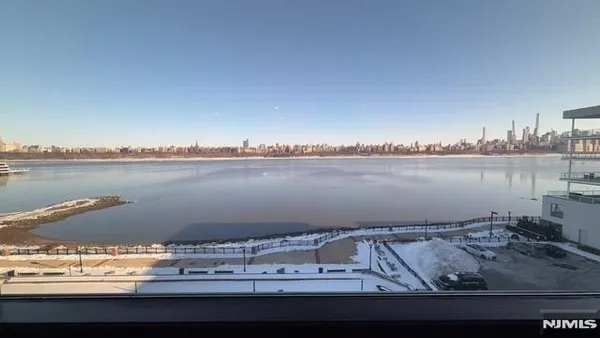 a view of a lake with houses in the back