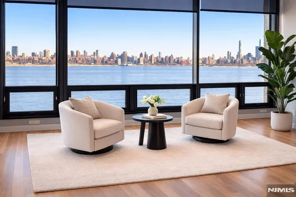 a living room with furniture a window and a potted plant