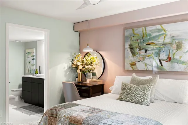 a bathroom with a sink vanity mirror and toilet