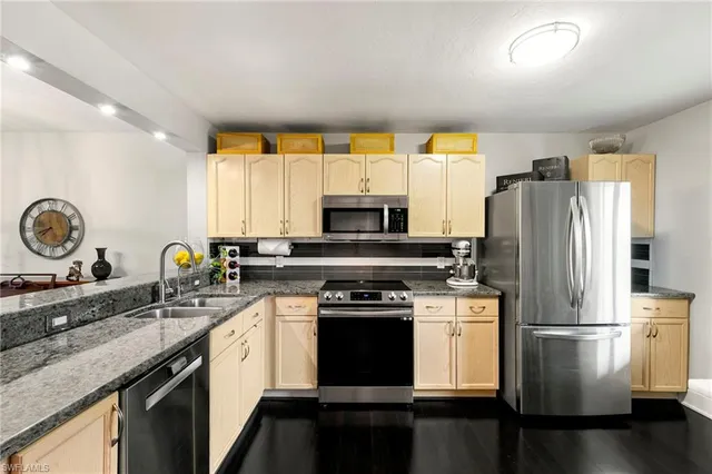 a kitchen with a sink stove and refrigerator