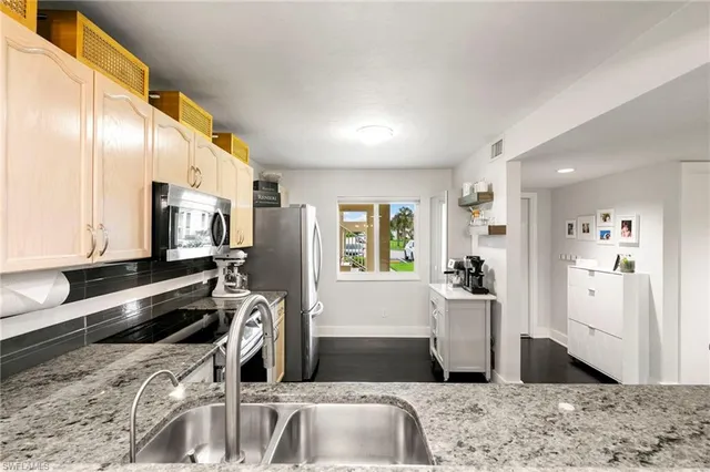 a kitchen with a sink a stove and cabinets