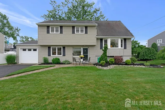 a aerial view of a house with a yard patio and fire pit