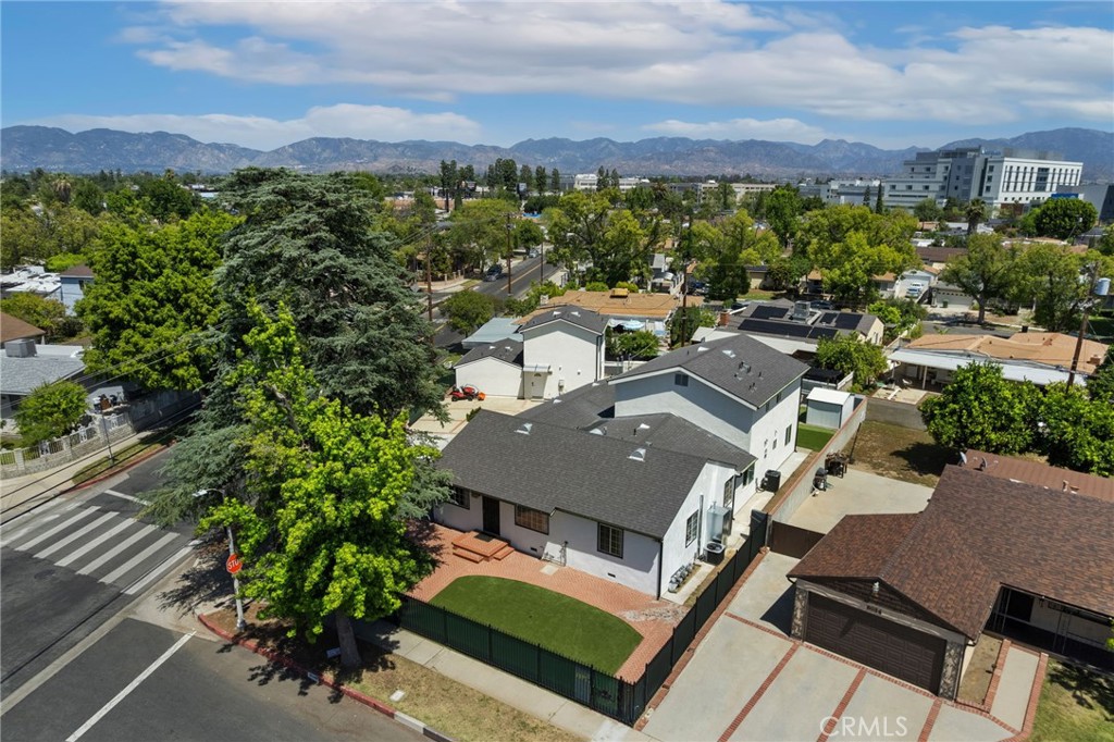 an aerial view of a house with a yard