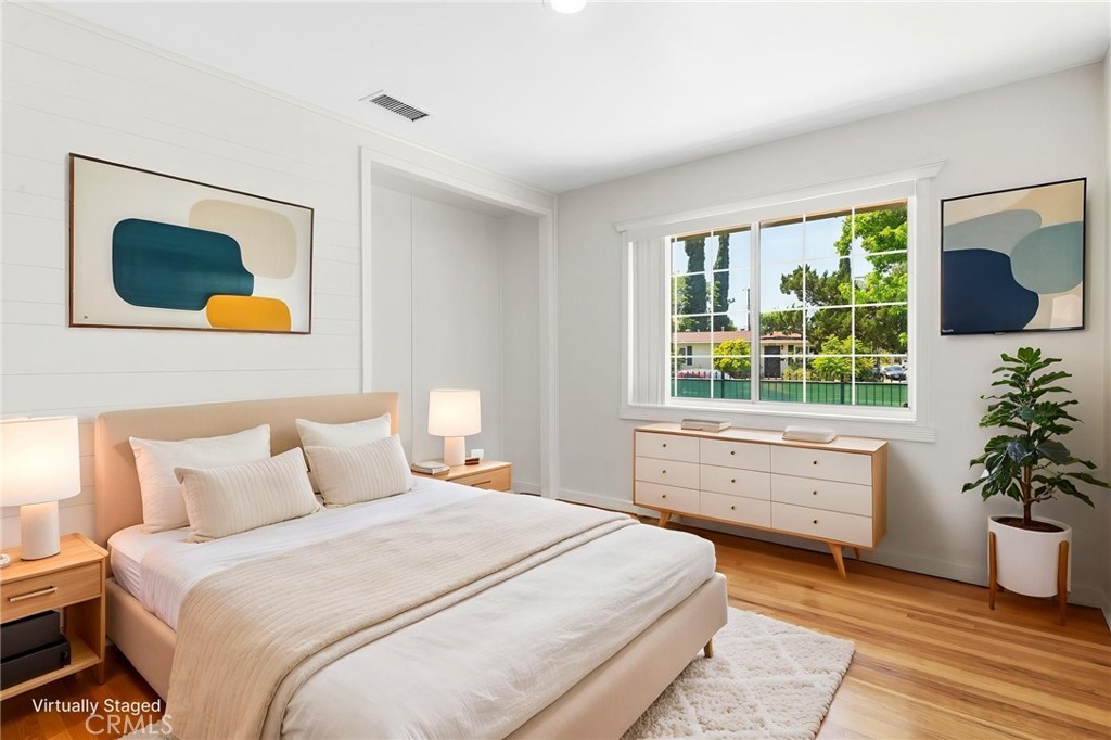8040 Ranchito Avenue Panorama City, CA 91402 - Photo 14 of 64 a bedroom with a bed and a potted plant