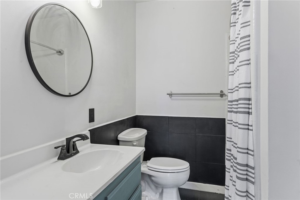 8040 Ranchito Avenue Panorama City, CA 91402 - Photo 18 of 64 a bathroom with a sink a toilet and a mirror