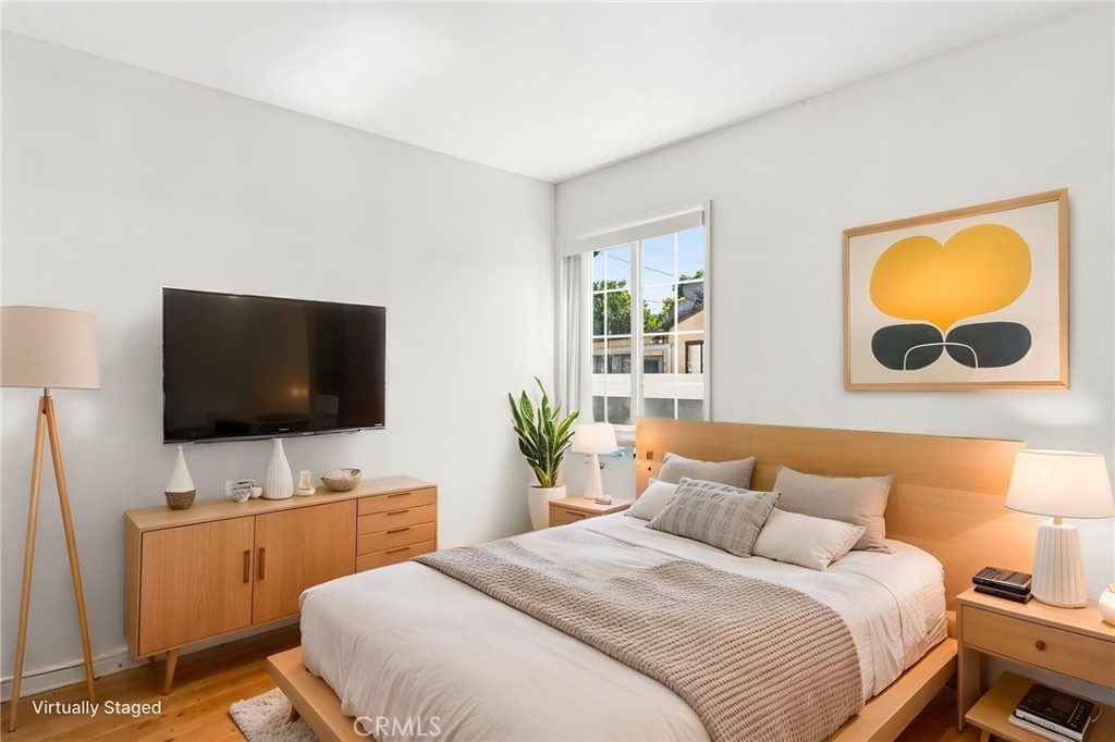 8040 Ranchito Avenue Panorama City, CA 91402 - Photo 19 of 64 a bedroom with a bed and a flat screen tv