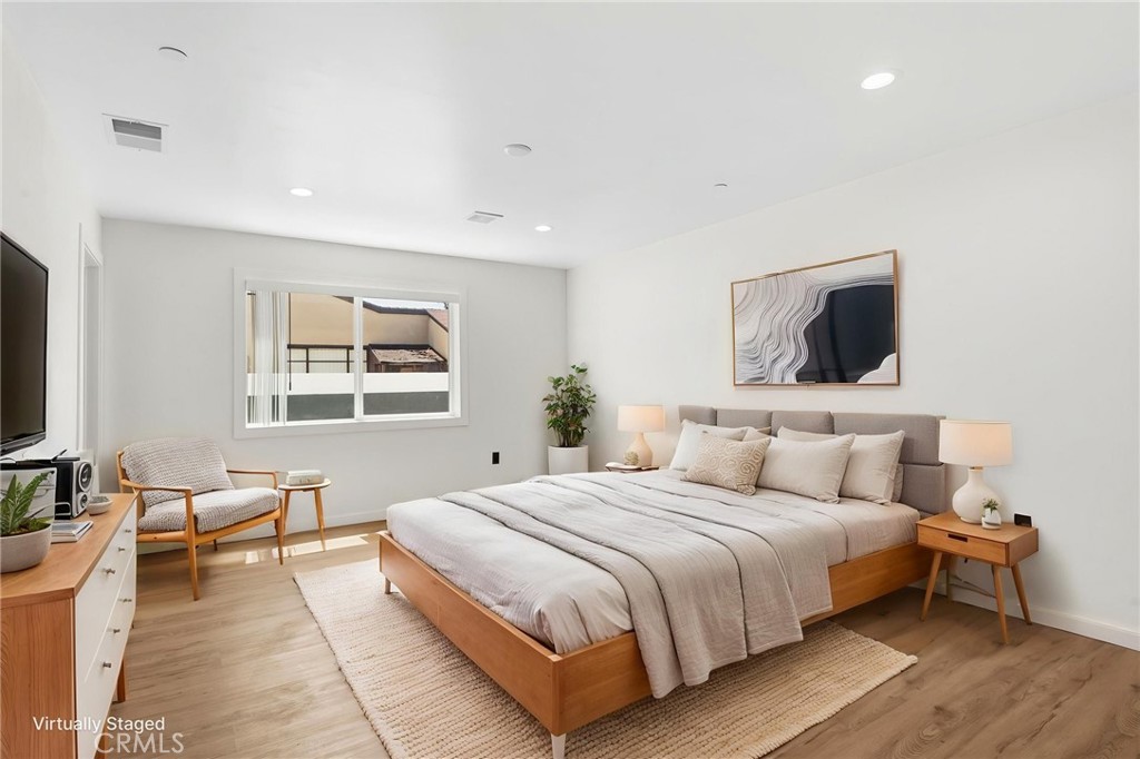 8040 Ranchito Avenue Panorama City, CA 91402 - Photo 21 of 64 a bedroom with a bed and a flat screen tv