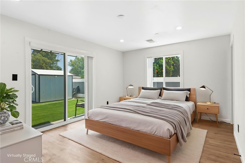 8040 Ranchito Avenue Panorama City, CA 91402 - Photo 25 of 64 a bedroom with a large bed and a large window