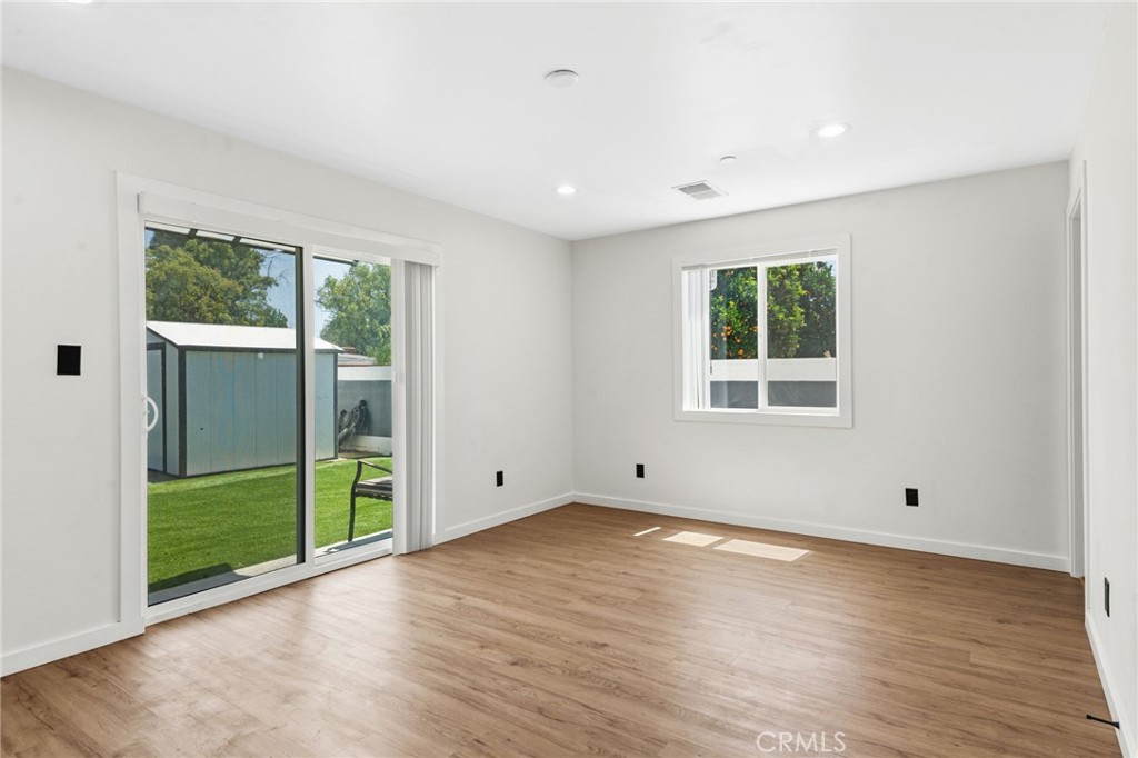 8040 Ranchito Avenue Panorama City, CA 91402 - Photo 26 of 64 wooden floor in an empty room with a window