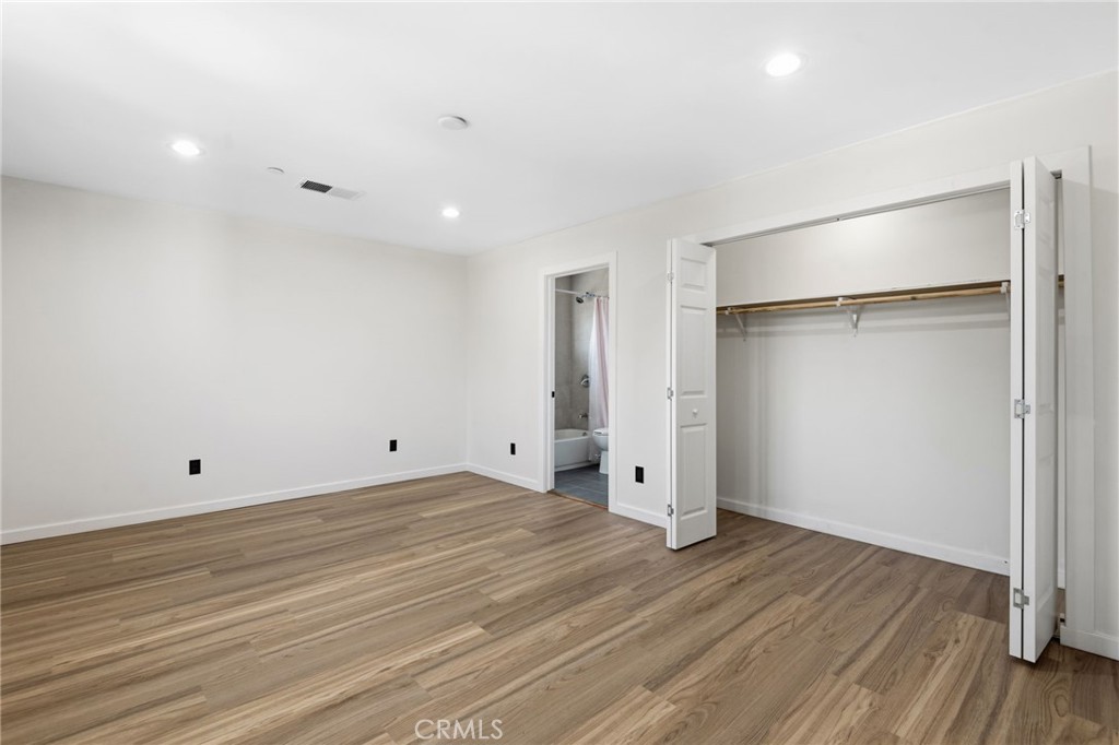 8040 Ranchito Avenue Panorama City, CA 91402 - Photo 30 of 64 a view of an empty room with wooden floor