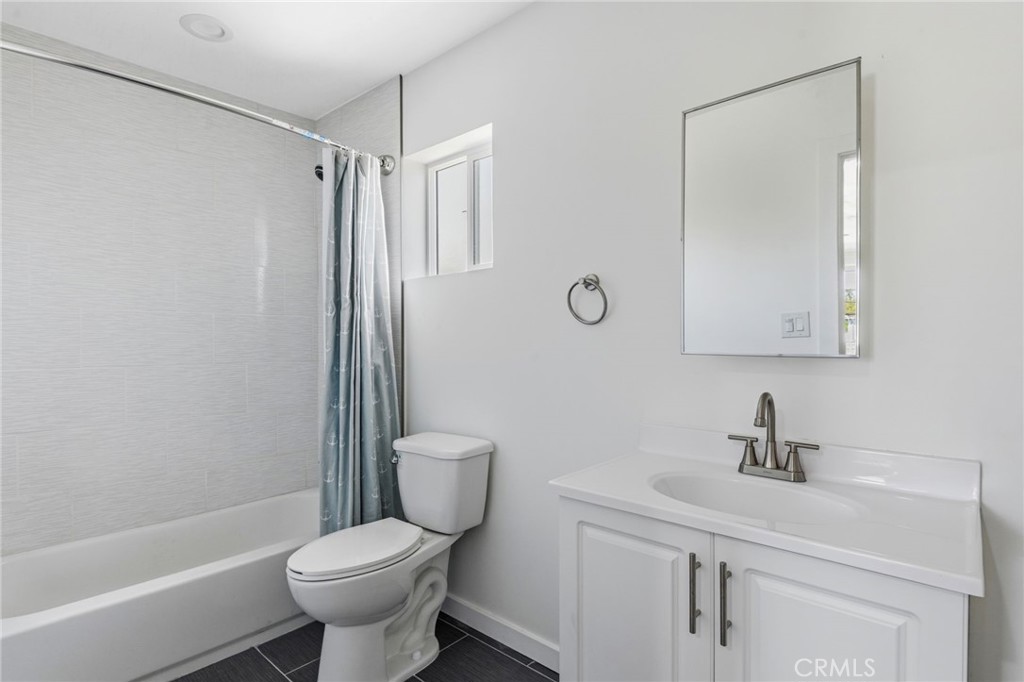 8040 Ranchito Avenue Panorama City, CA 91402 - Photo 34 of 64 a bathroom with a toilet sink shower and mirror