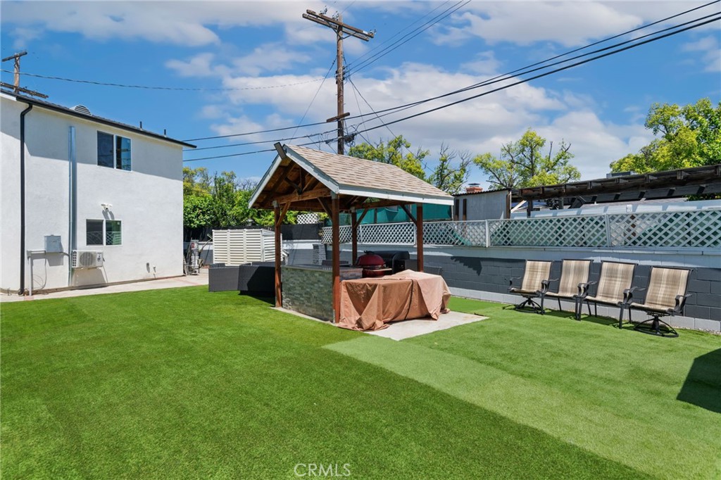 8040 Ranchito Avenue Panorama City, CA 91402 - Photo 38 of 64 a view of a house with a backyard and patio