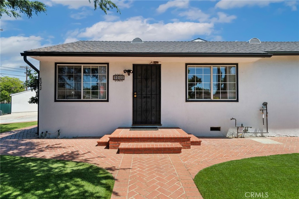8040 Ranchito Avenue Panorama City, CA 91402 - Photo 4 of 64 a front view of a house with a yard