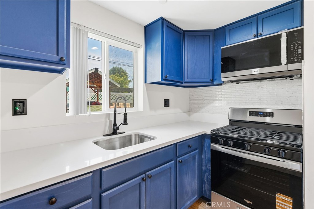 8040 Ranchito Avenue Panorama City, CA 91402 - Photo 44 of 64 a kitchen with stainless steel appliances a sink a stove and microwave