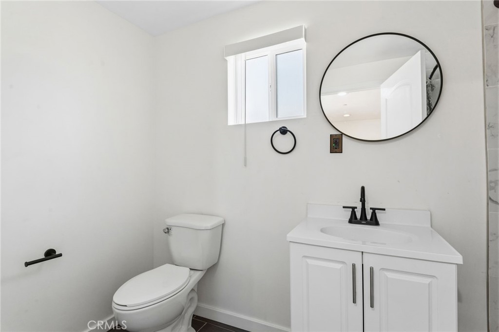 8040 Ranchito Avenue Panorama City, CA 91402 - Photo 45 of 64 a bathroom with a toilet a sink and mirror
