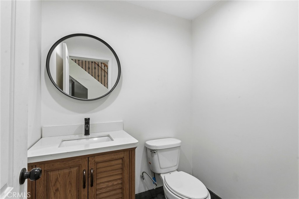 8040 Ranchito Avenue Panorama City, CA 91402 - Photo 52 of 64 a bathroom with a toilet a sink and a mirror