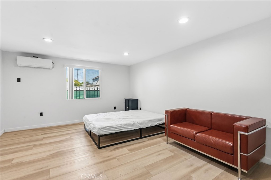 8040 Ranchito Avenue Panorama City, CA 91402 - Photo 54 of 64 a bedroom with a bed couch and window