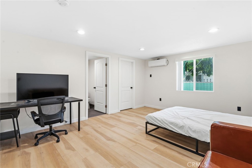 8040 Ranchito Avenue Panorama City, CA 91402 - Photo 55 of 64 a bedroom with a bed and a desk