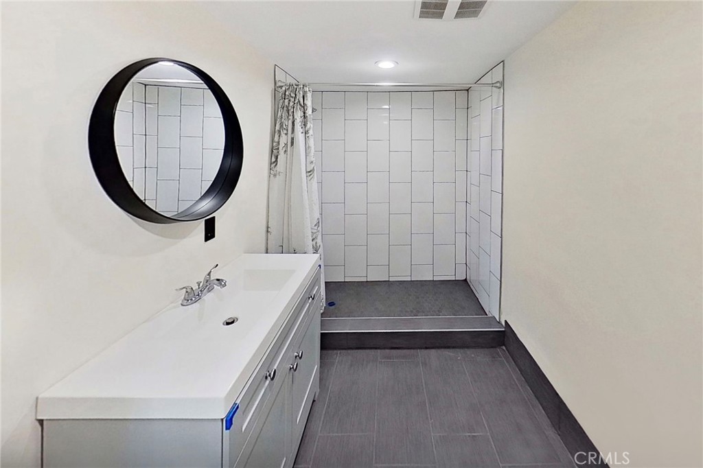 8040 Ranchito Avenue Panorama City, CA 91402 - Photo 56 of 64 a bathroom with a sink a toilet and a mirror