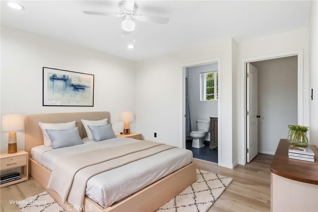 8040 Ranchito Avenue Panorama City, CA 91402 - Photo 57 of 64 a bedroom with a large bed and a chandelier