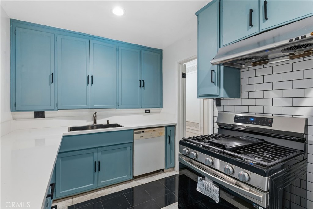 8040 Ranchito Avenue Panorama City, CA 91402 - Photo 10 of 64 a kitchen with sink stove and cabinets