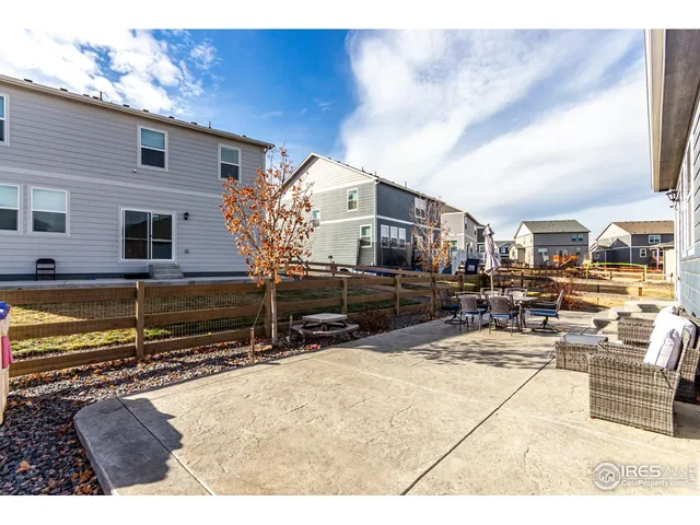 a view of a chairs and tables in the back yard of the house
