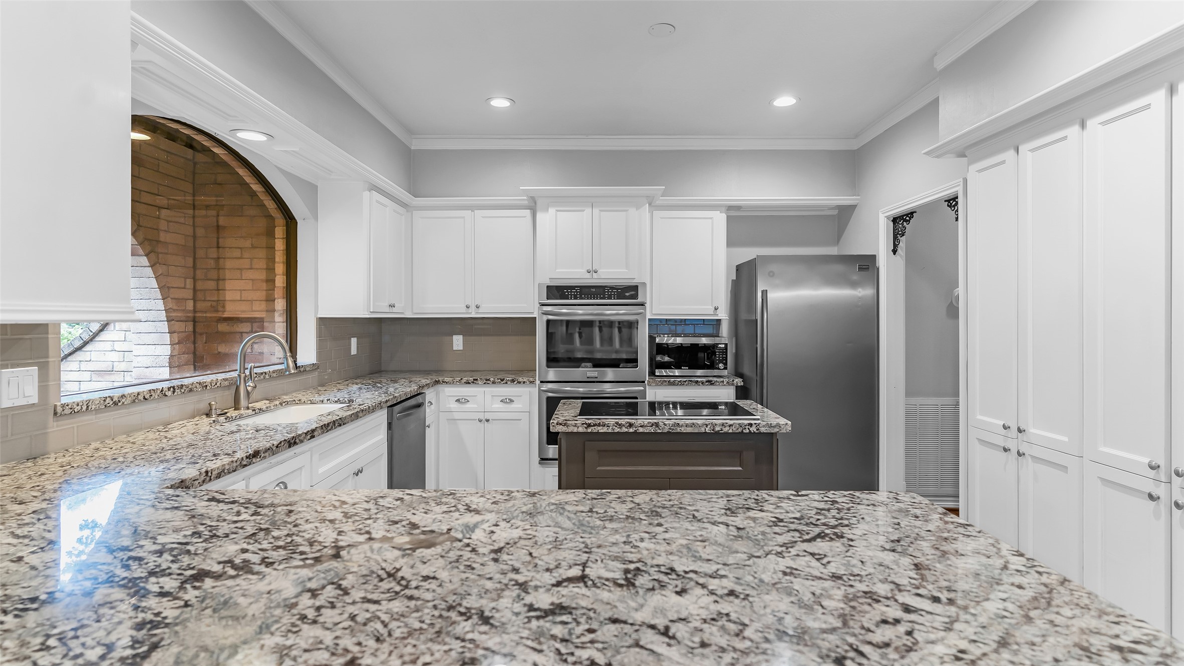 2607 Laurel Ridge Drive Houston, TX 77345 - Photo 12 of 47 a kitchen with granite countertop a refrigerator sink stove and oven