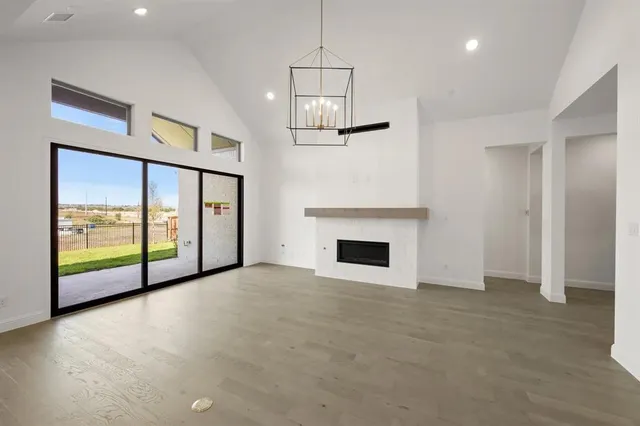 a view of an empty room with a fireplace and a window