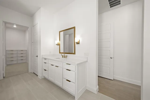 walk in closet with cabinets