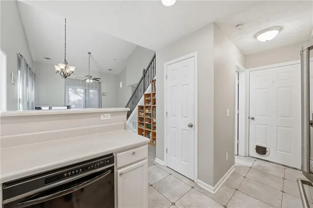 a view of a kitchen with a stove and a chandelier