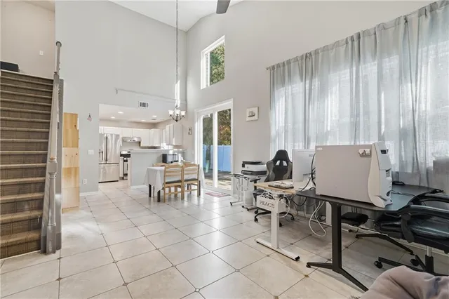 a view of a workspace with furniture and a window