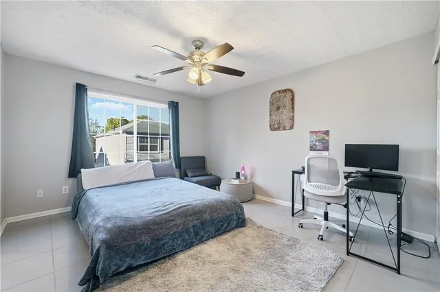 a bedroom with a bed and a desk