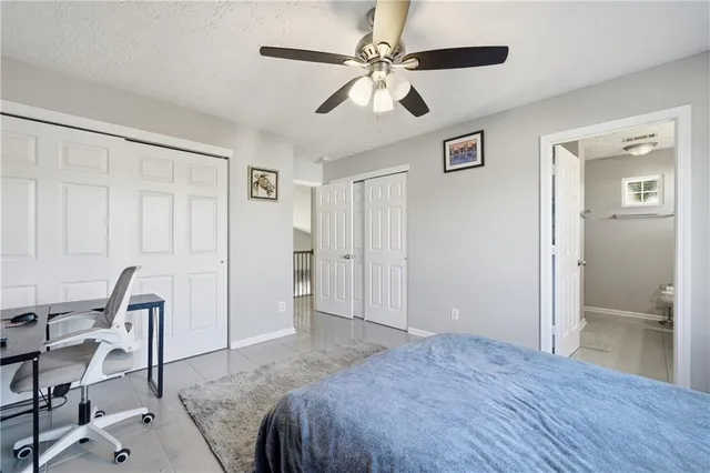 a spacious bedroom with a bed and a table in it