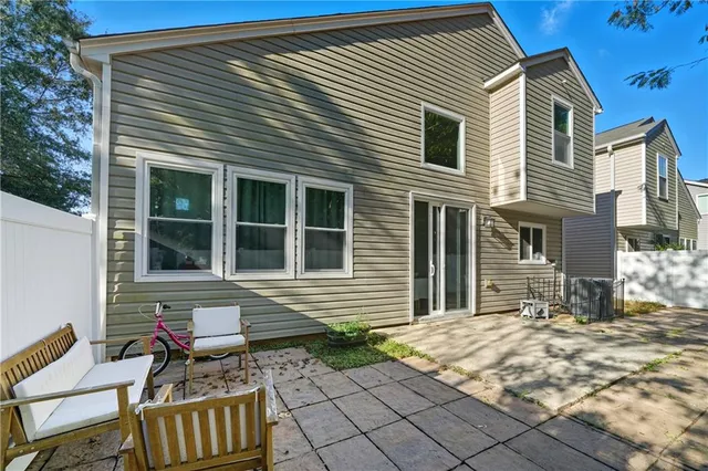 a front view of a house with outdoor seating