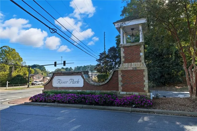 a sign that is sitting in front of flowers