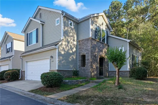 a front view of a house with garden