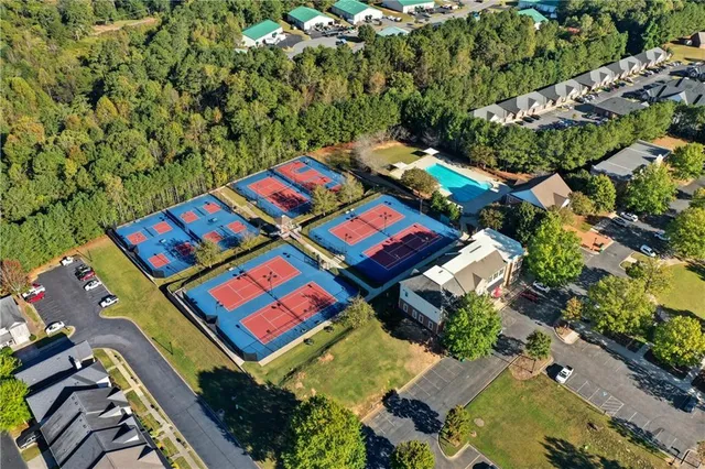 an aerial view of a residential houses with yard