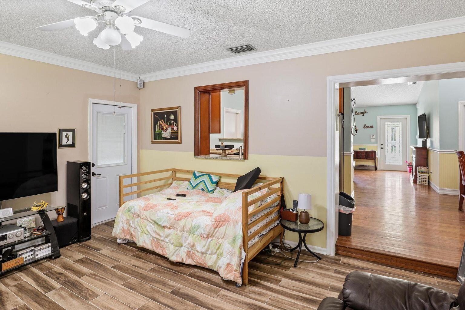 1101 Julia Heights Drive Lantana, FL 33462 - Photo 11 of 19 a bedroom with a bed and a flat tv screen on dresser