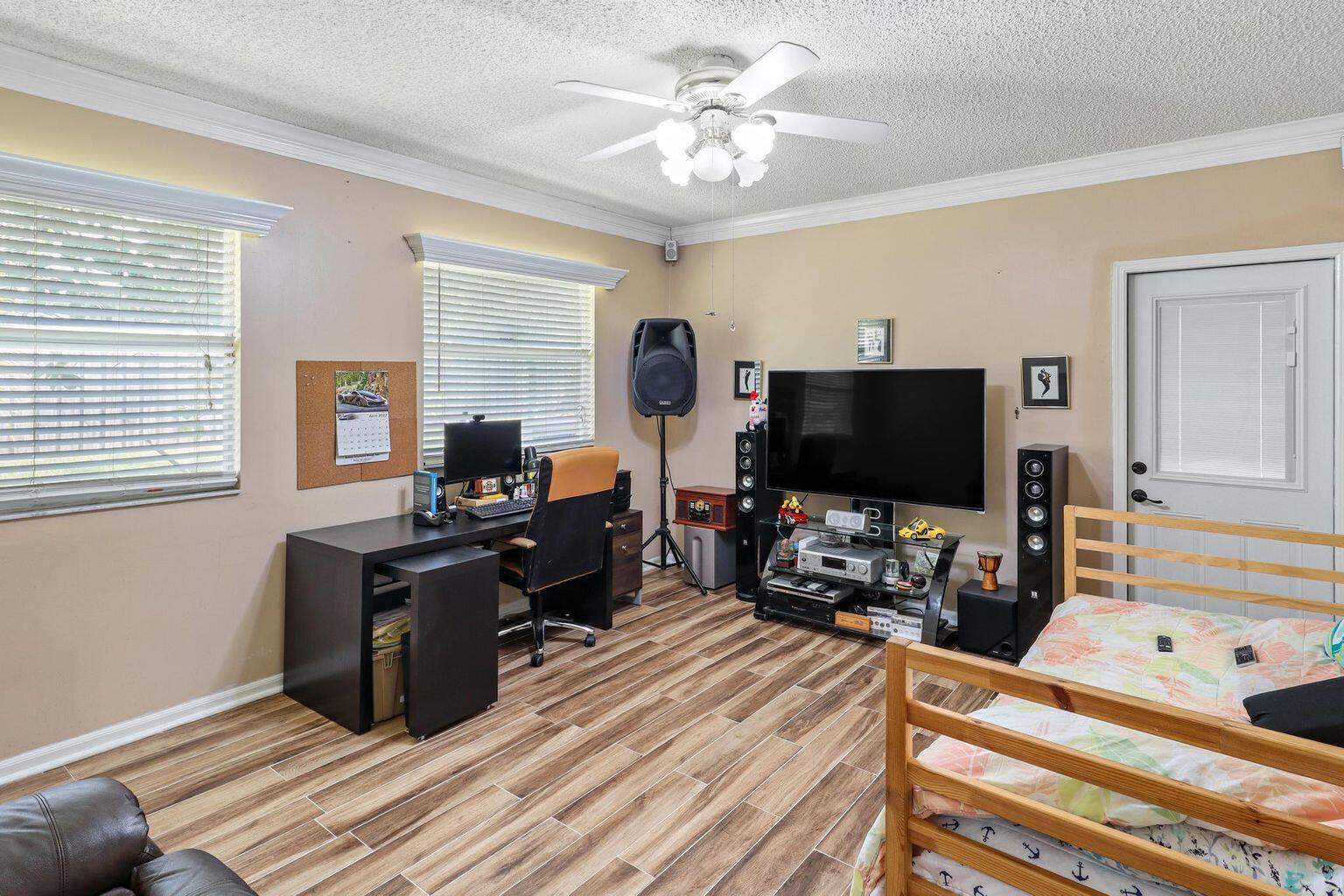 1101 Julia Heights Drive Lantana, FL 33462 - Photo 12 of 19 a bedroom with a bed and a flat screen tv