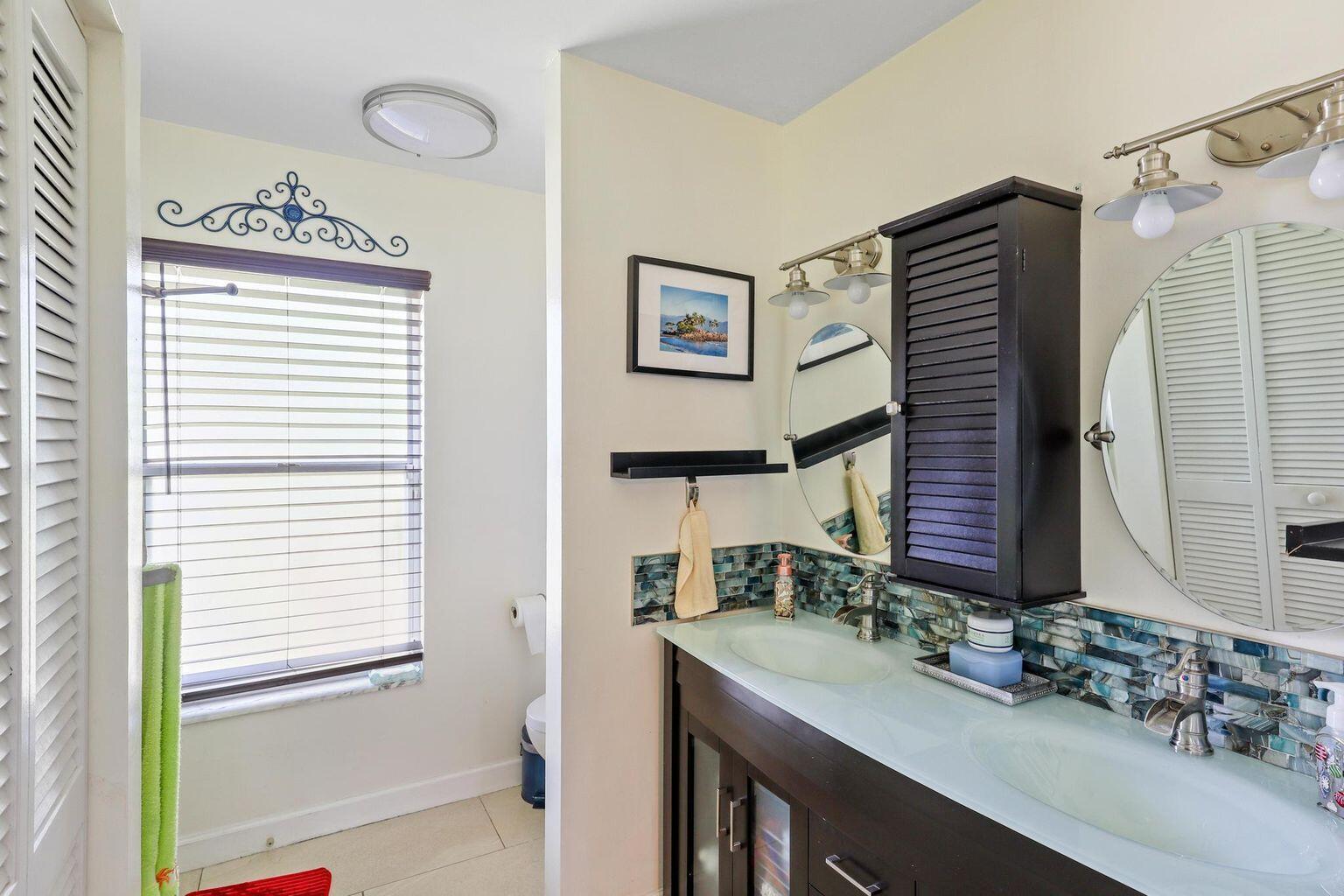 1101 Julia Heights Drive Lantana, FL 33462 - Photo 14 of 19 a bathroom with a sink and a mirror