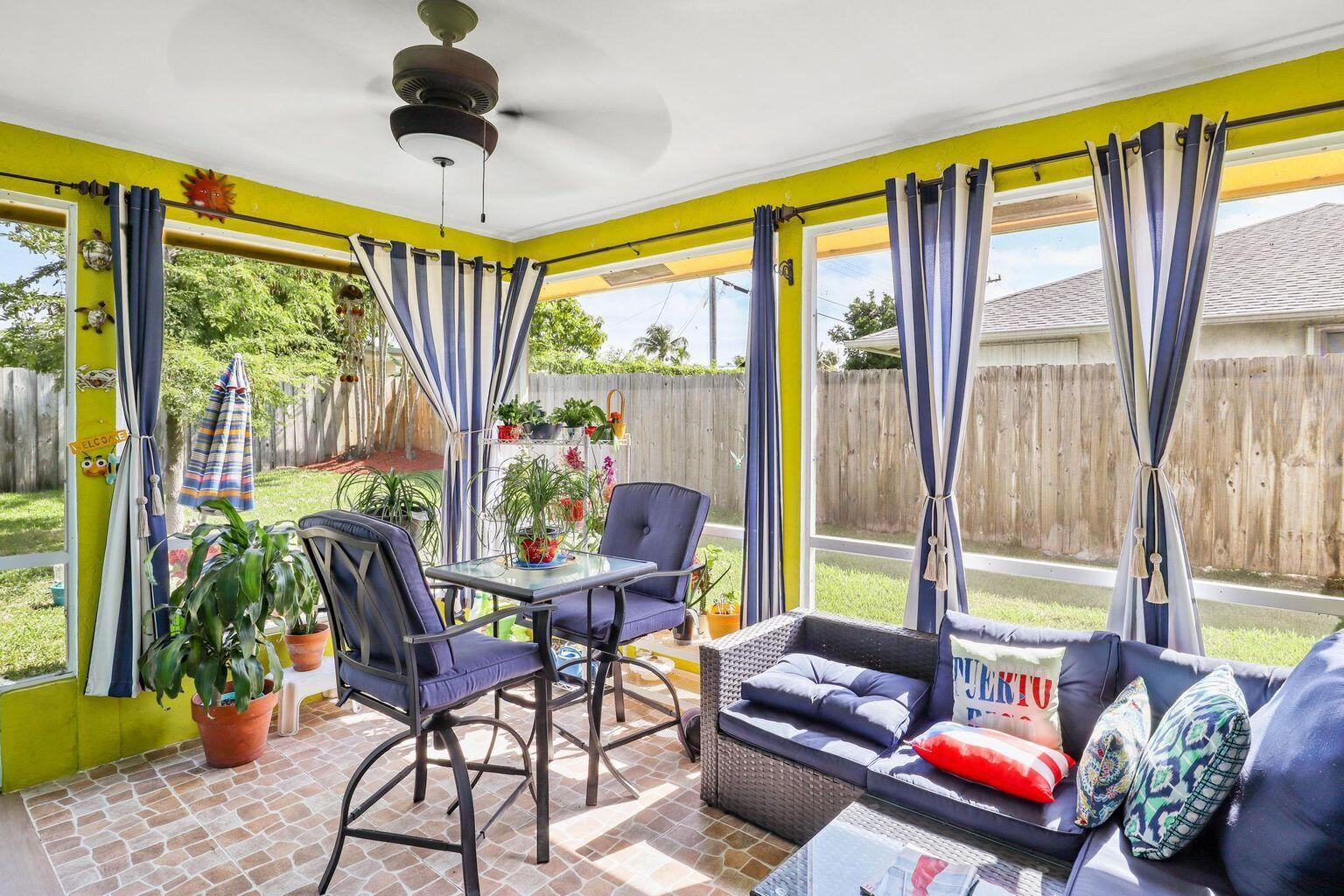 1101 Julia Heights Drive Lantana, FL 33462 - Photo 15 of 19 a living room filled with furniture and a floor to ceiling window