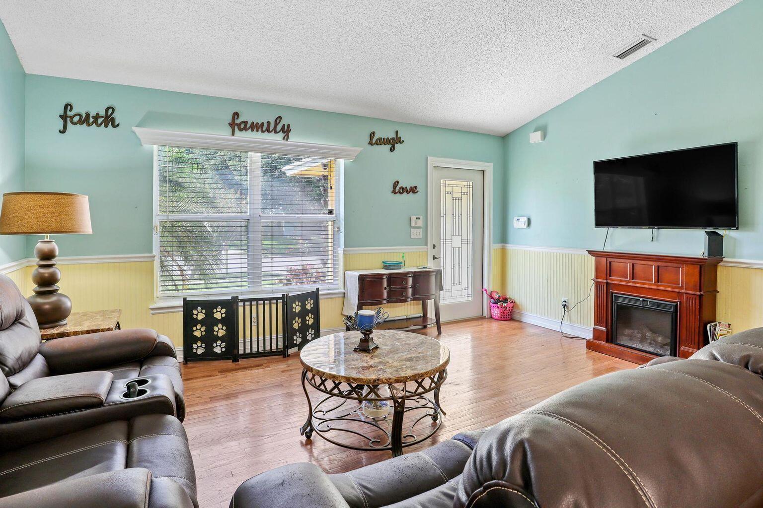 1101 Julia Heights Drive Lantana, FL 33462 - Photo 4 of 19 a living room with fireplace furniture and a flat screen tv