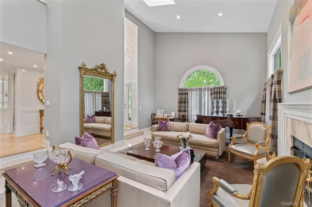 a living room with furniture a fireplace and a large window