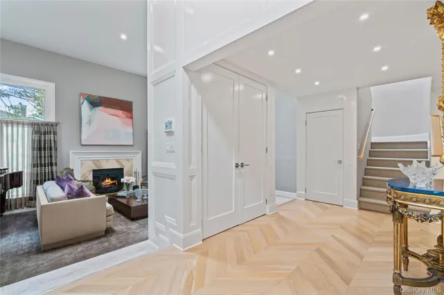 a living room with furniture a fireplace and a chandelier