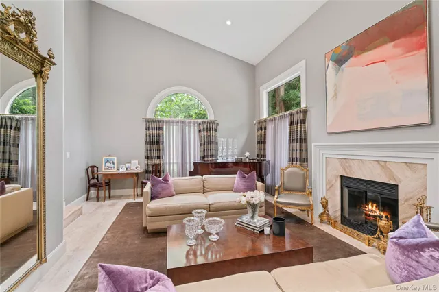 a living room with furniture fireplace and a large window