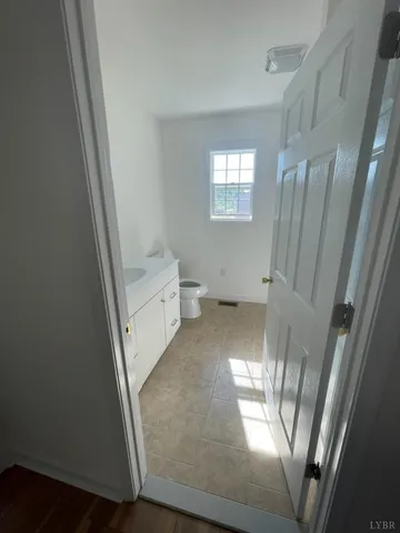 a view of a livingroom with wooden floor and staircase